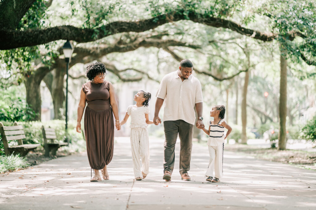 Kids with parents walking in Forsyth Park, one of the best Savannah playgrounds.